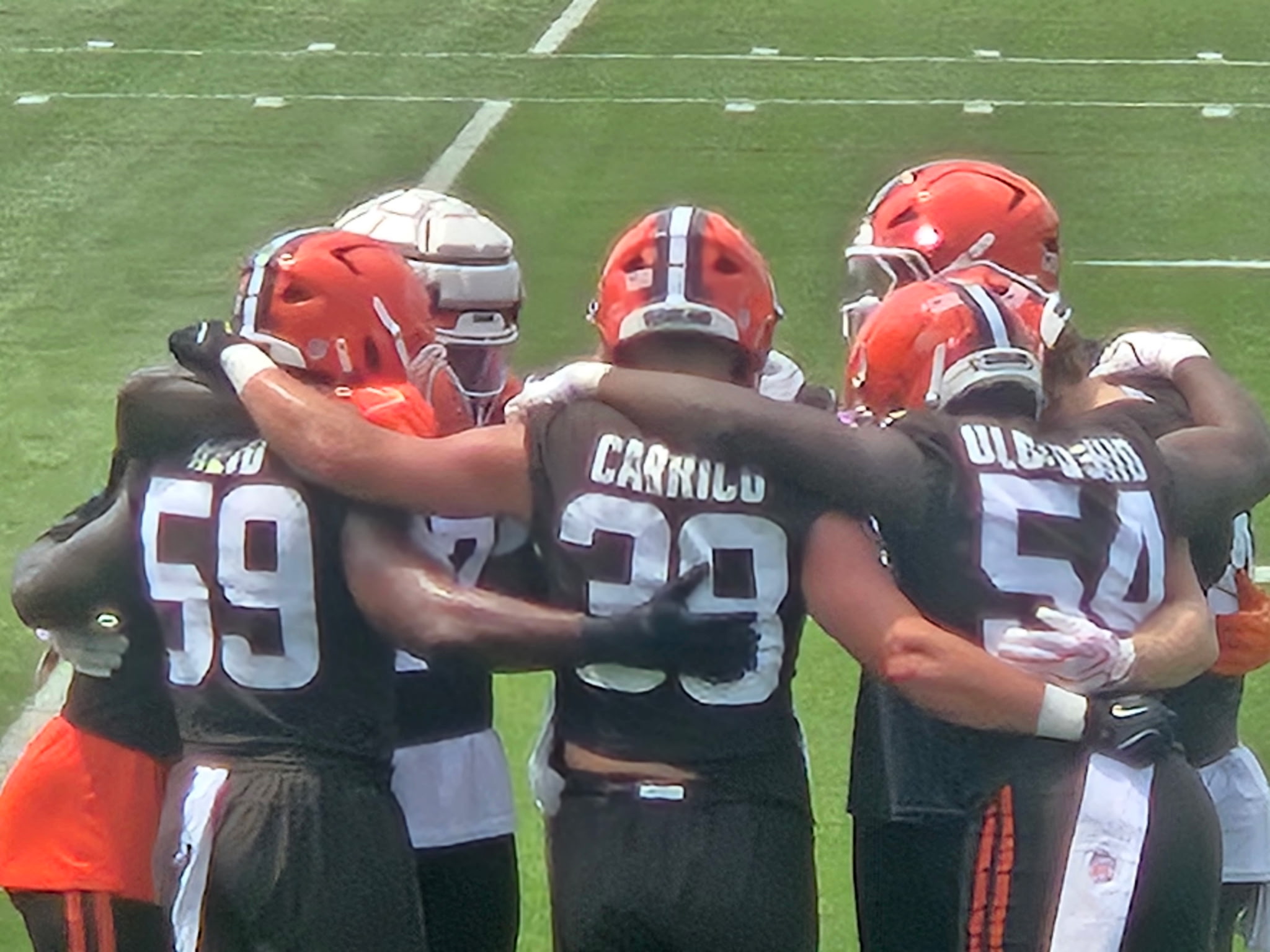 Cleveland Browns players in a huddle